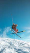 skier jumping over snowy slope