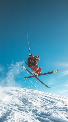 Skier carving through powder on all-mountain skis