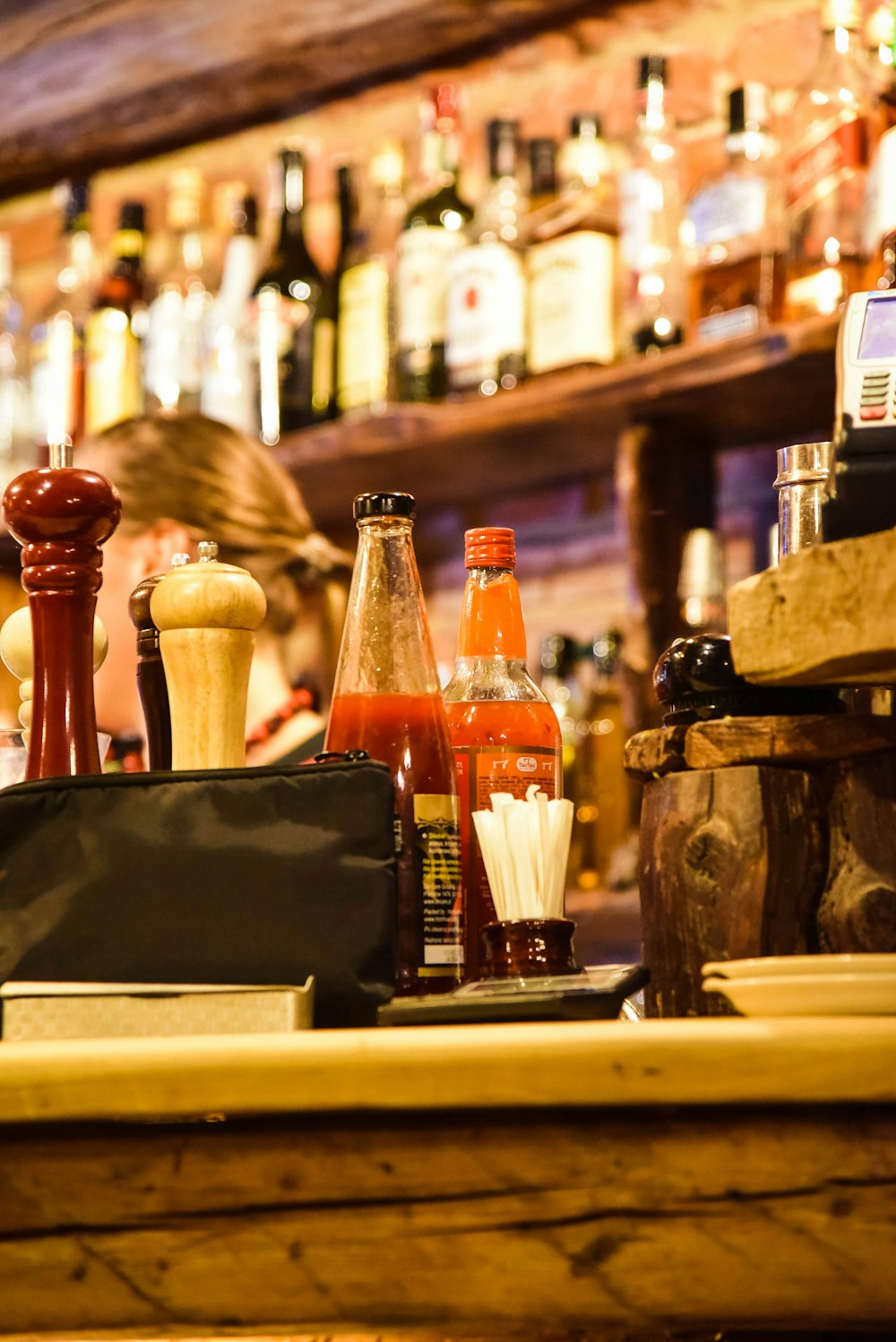 a bar with bottles of alcohol on the counter
