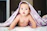 baby under purple blanket