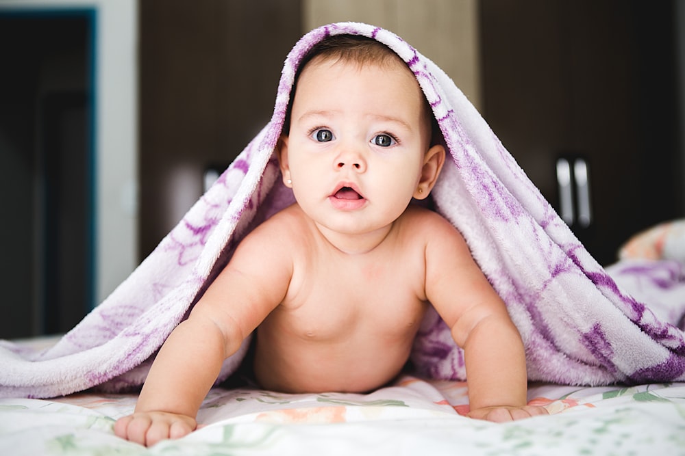 bambino sotto la coperta viola