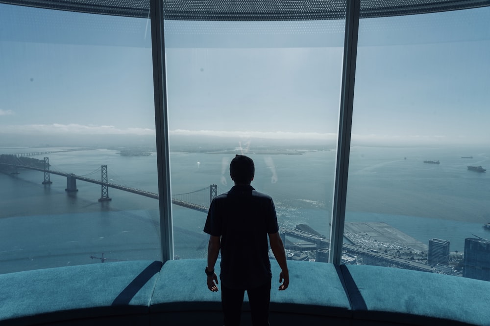 man standing in front of glass windows