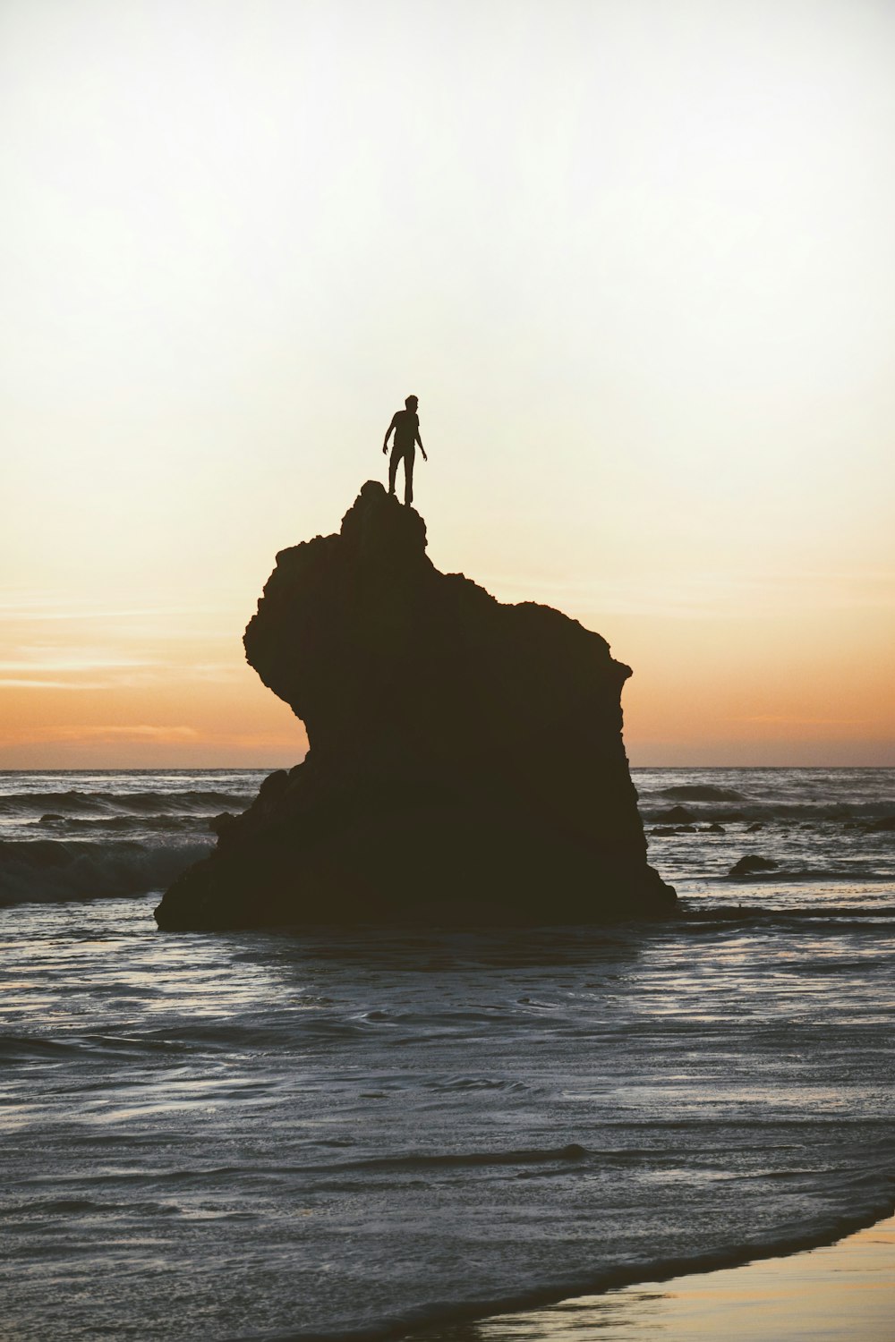 silhouette of a man on a rock