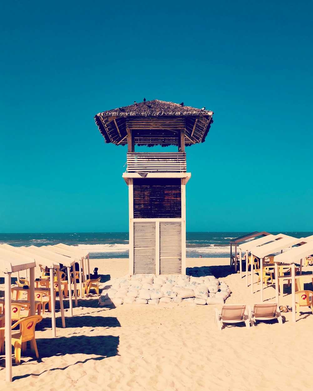 brown and white wooden lifeguard tower