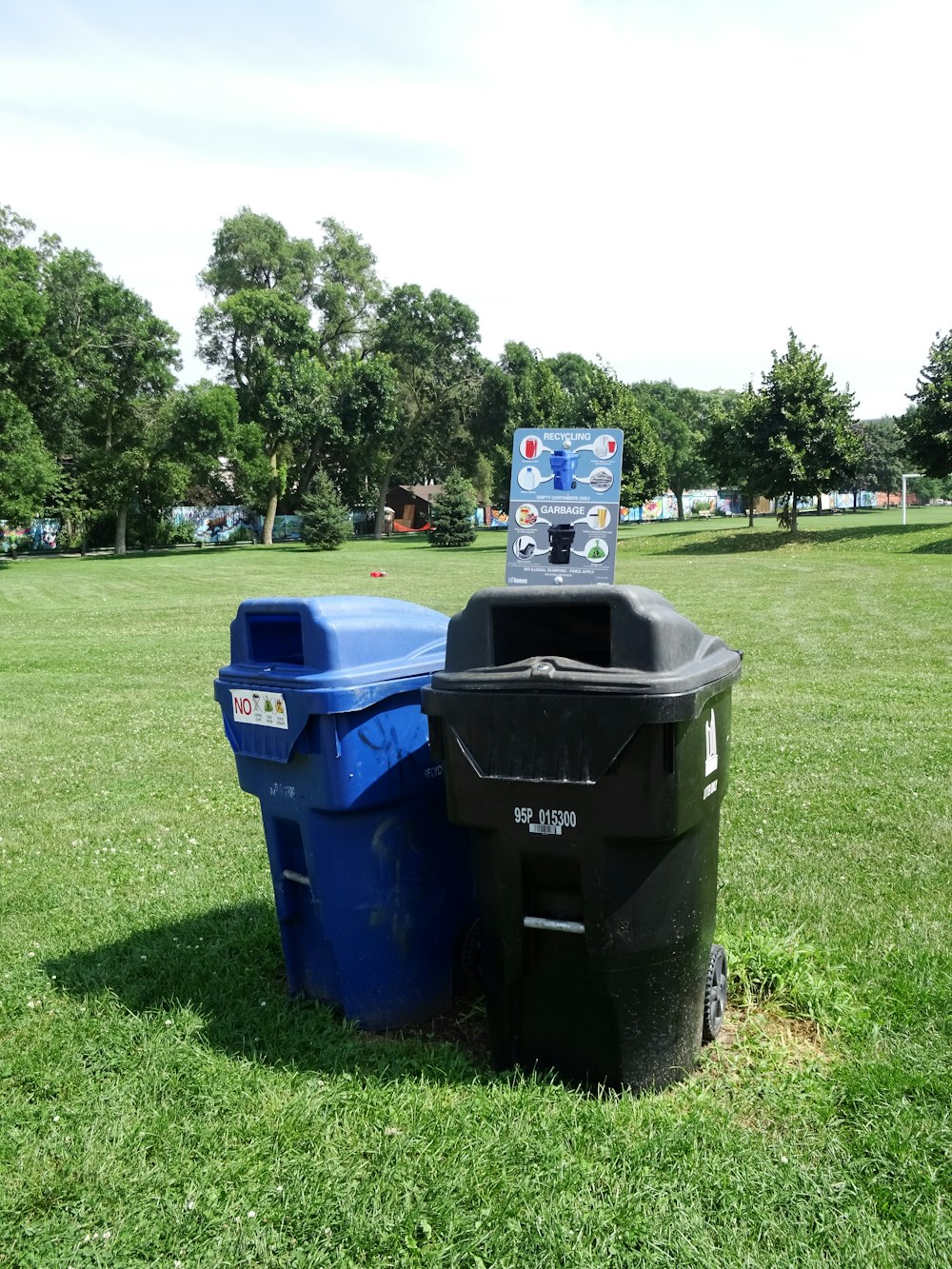 two black and blue trash cans