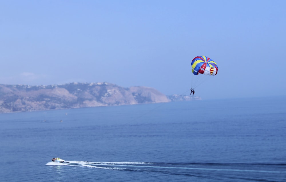 people with a colorful parachute