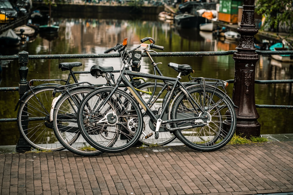 bikes parked beside bridge railing