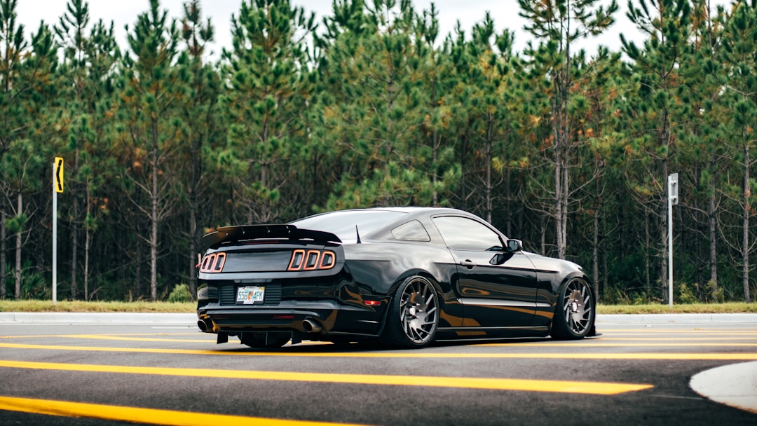 black coupe on the road