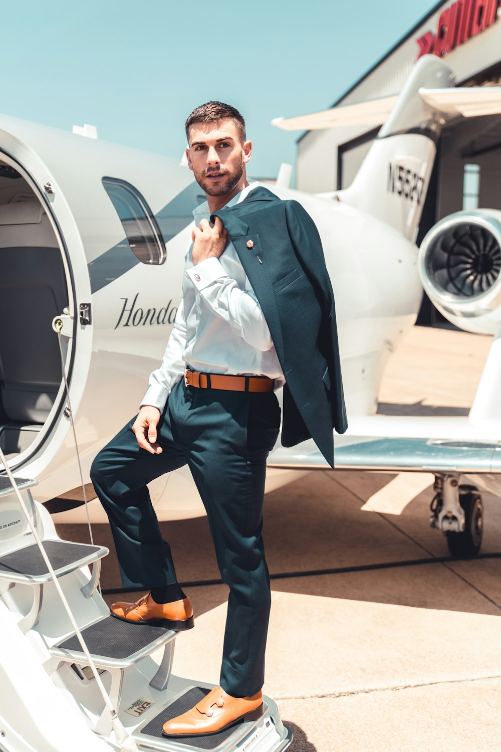 man standing on plane stairs