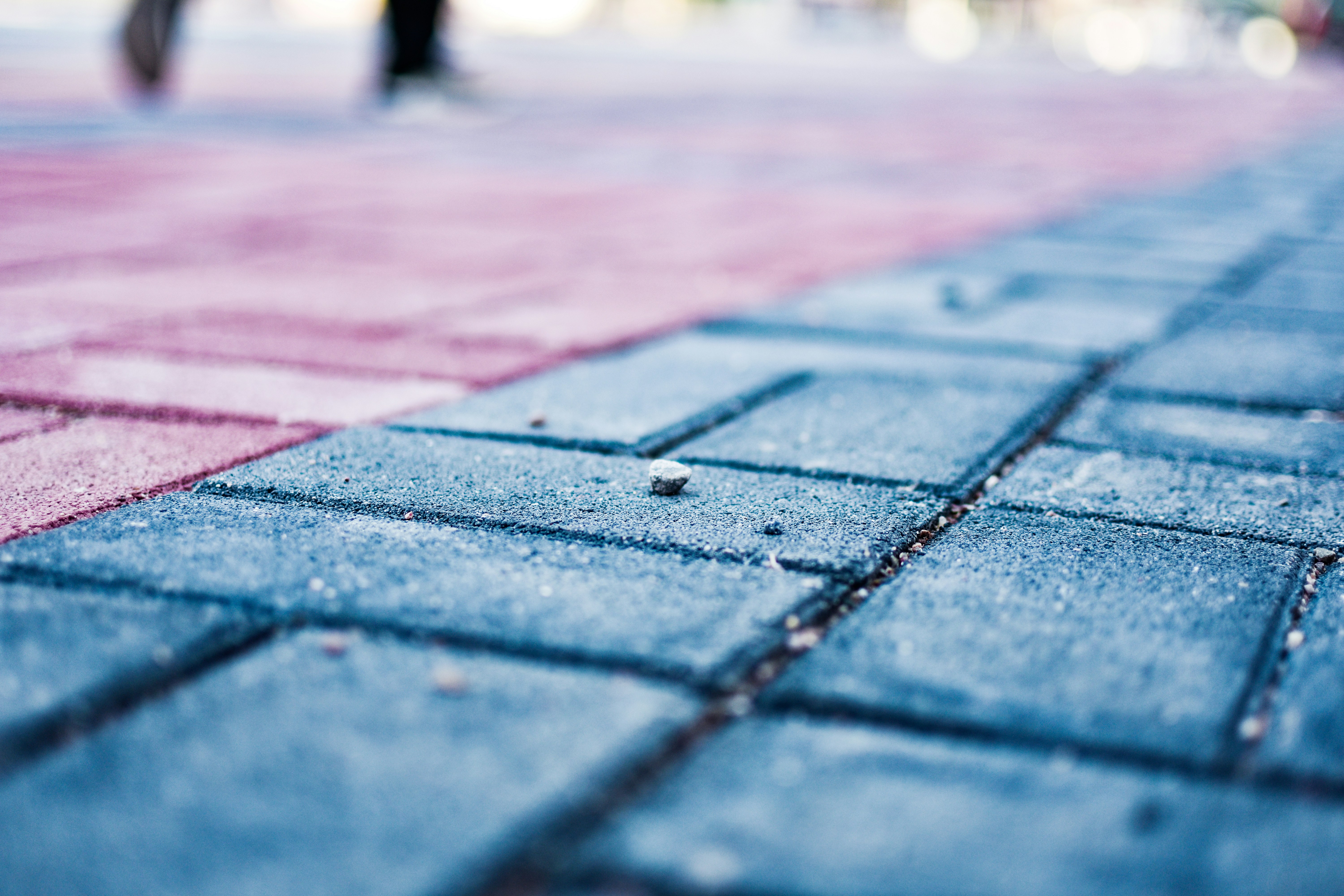 a close up of a sidewalk with a person walking on it