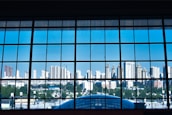 A close-up of a sparkling clean window with a cityscape in the background.