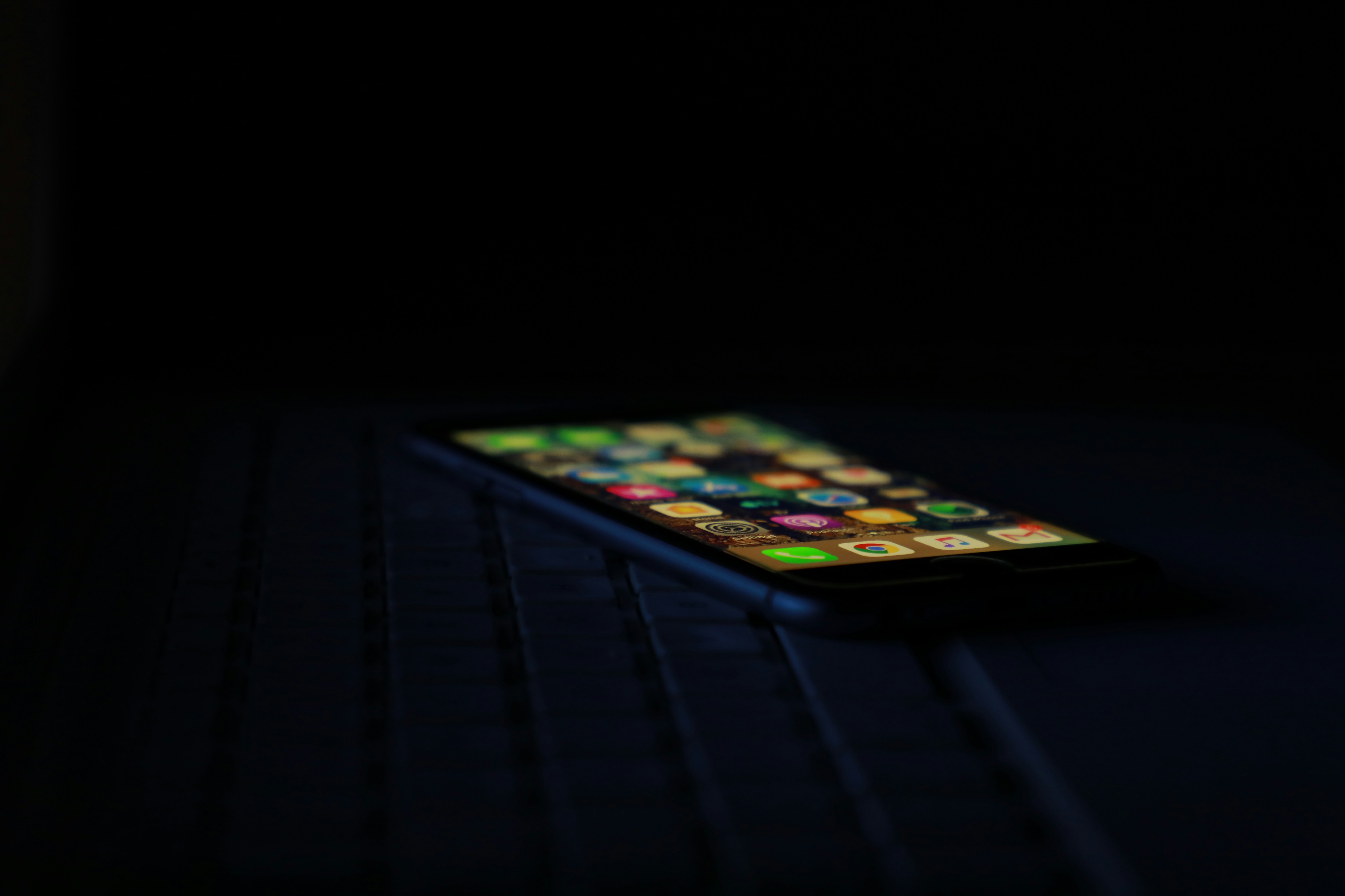 Android smartphone with glowing app interface in dark environment