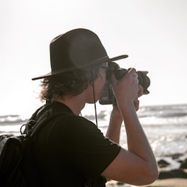 man taking photo using DSLR camera
