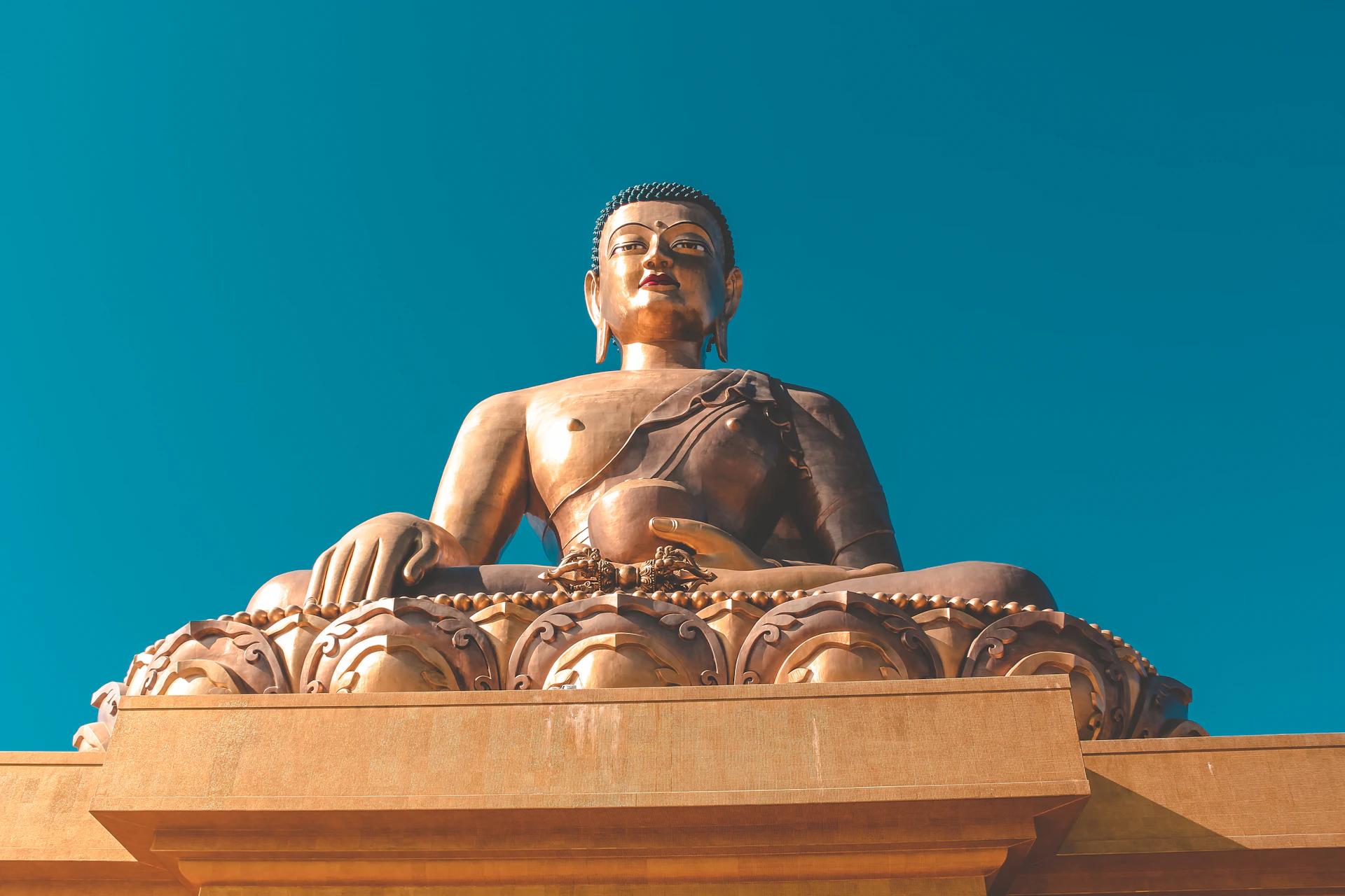 golden Gautam Buddha under blue sky