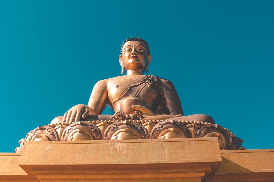 golden Gautam Buddha under blue sky