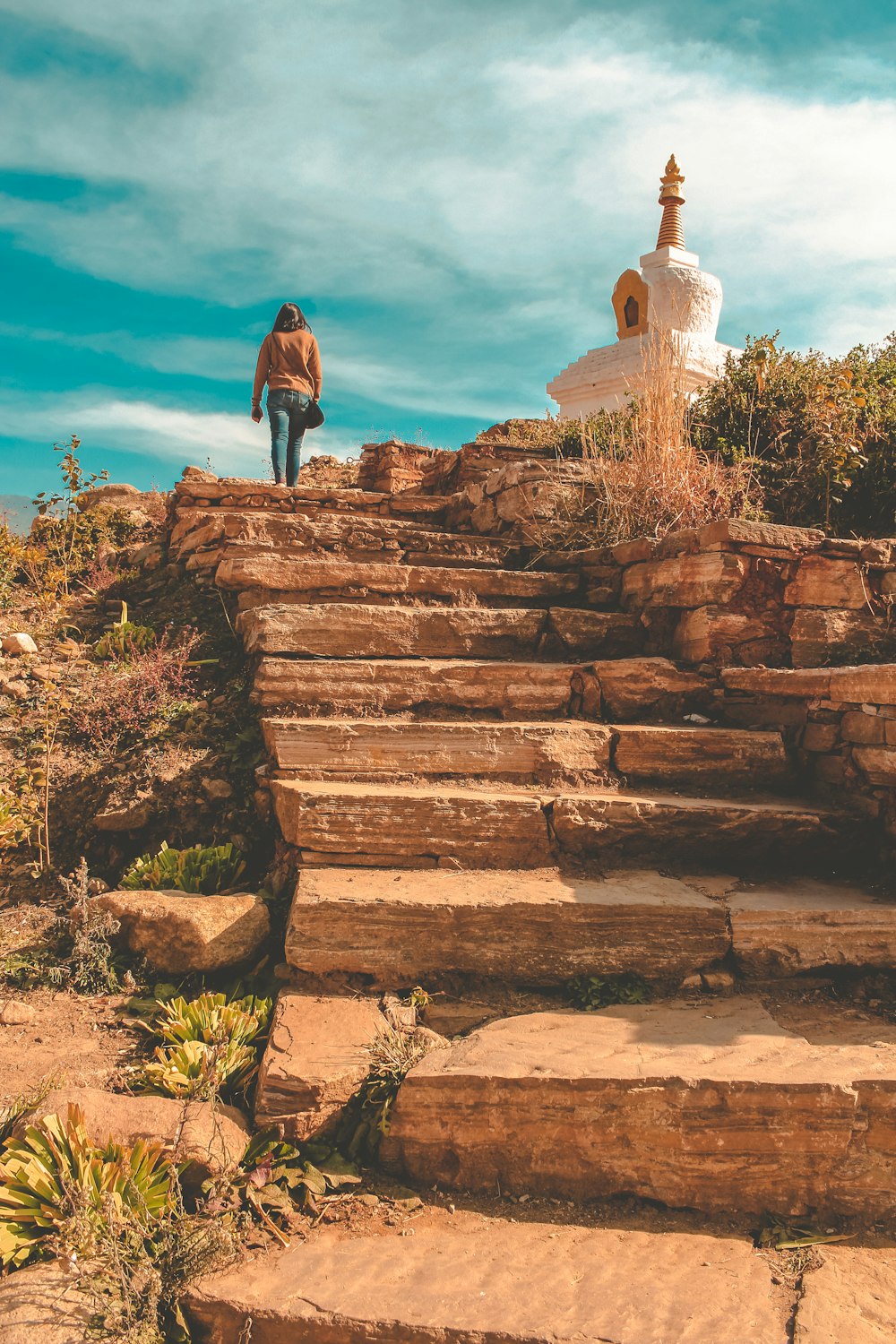 woman at a brown stone stairs