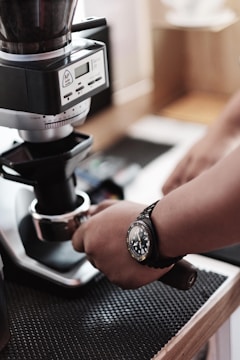 A technician repairing a coffee grinder in a workshop.