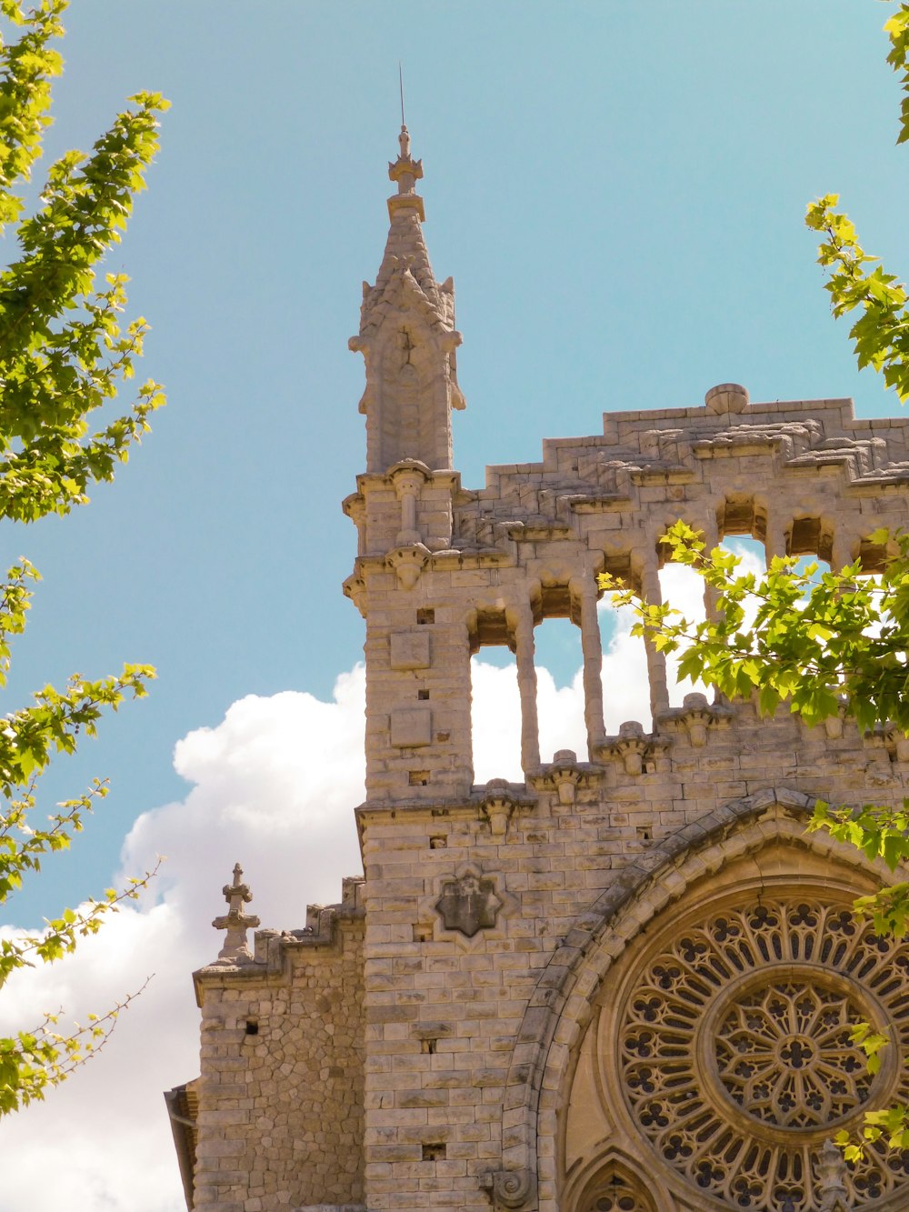 brown historic church under blue and white skies