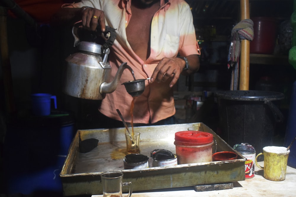 woman pouring coffee onto cup