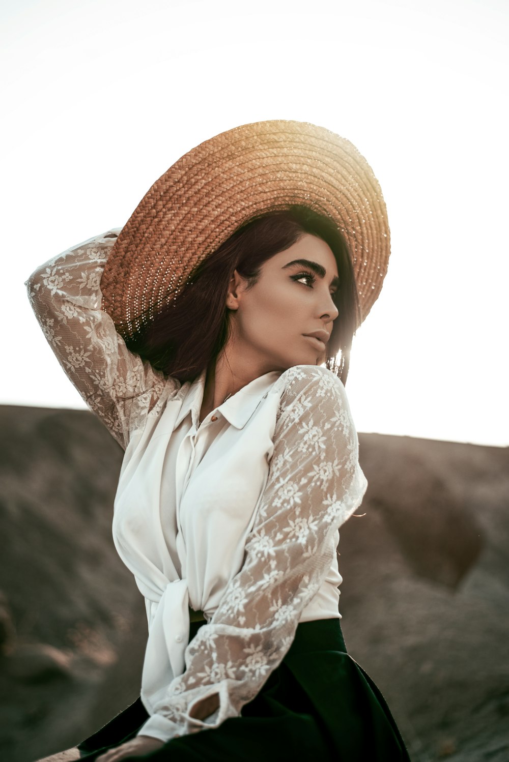 woman sitting and holding hat