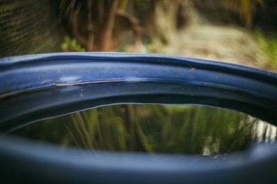 A small blue water tank placed in a garden.