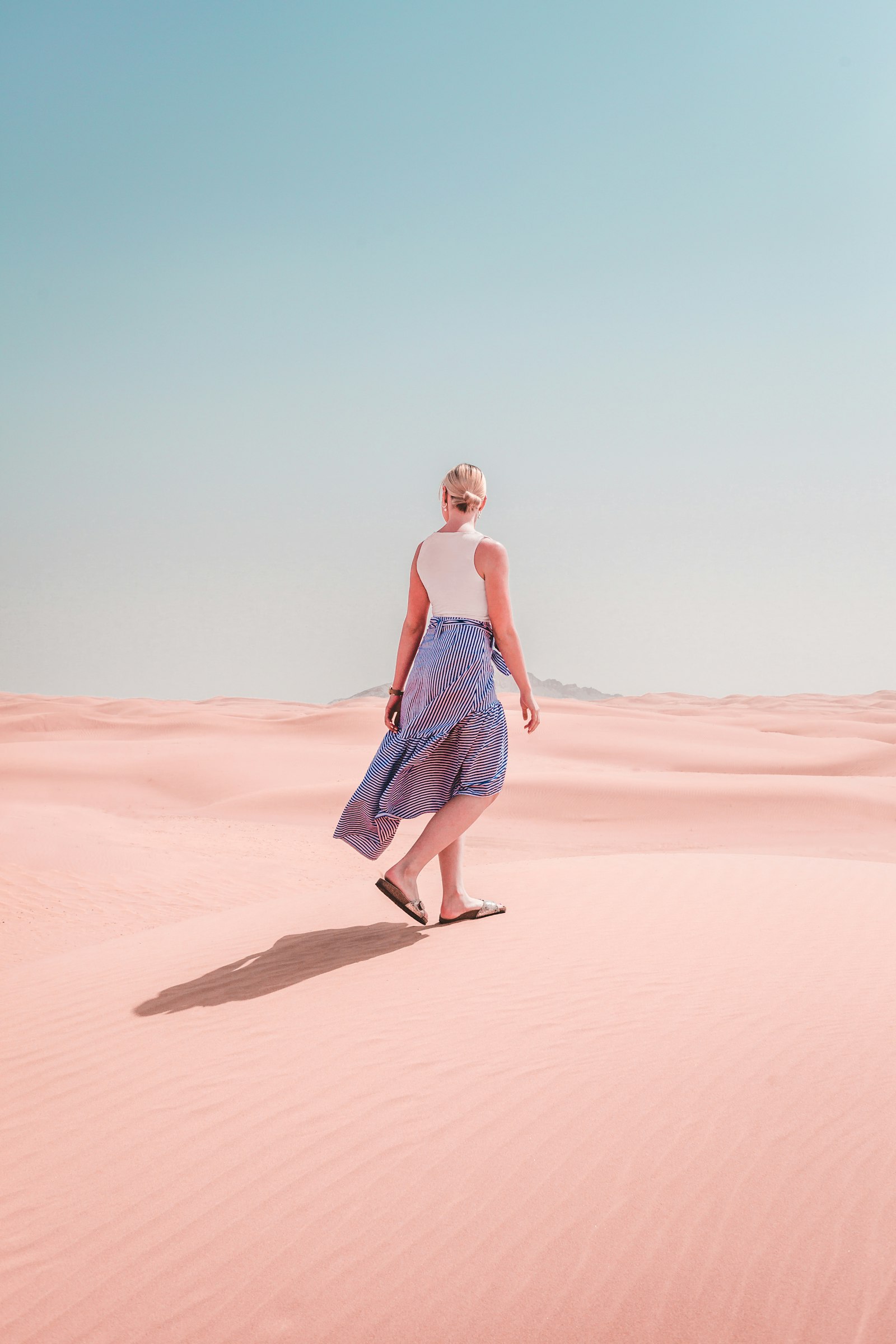 Canon EF 35mm F2 sample photo. Woman wears dress walks photography