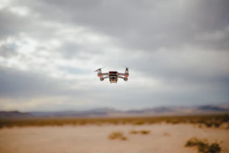 A drone capturing sweeping aerial shots over a vast desert landscape.