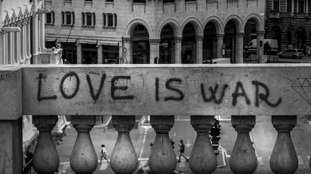 gray concrete wall with love is war text