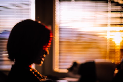 Softly lit silhouette of Lola against a sunset, evoking mystery and allure.