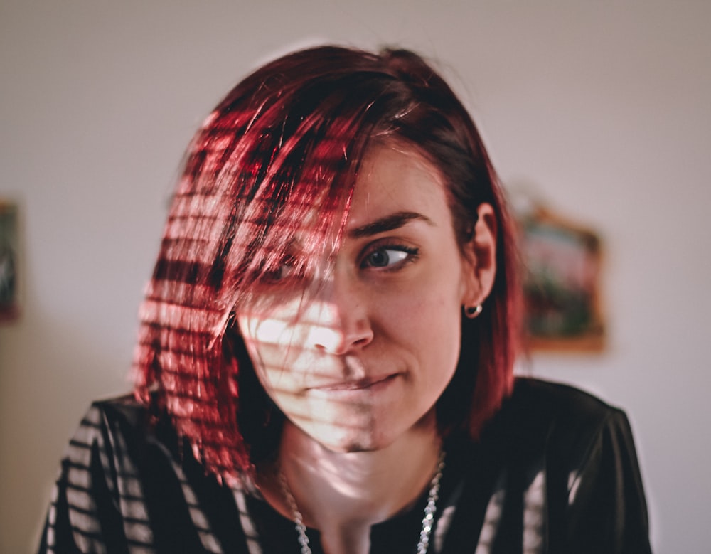 lights from window reflecting on woman biting lip