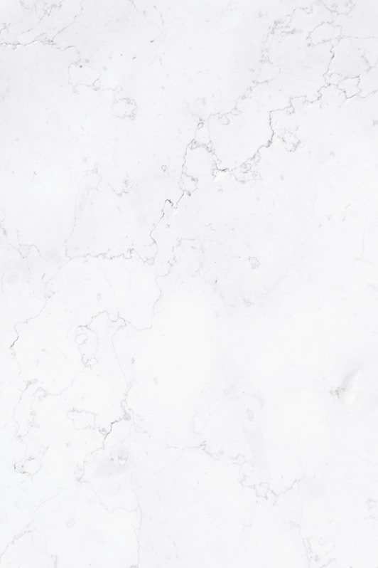 a close up of a white marble surface