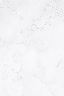 a close up of a white marble surface