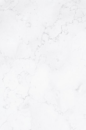 a close up of a white marble surface
