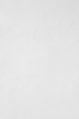 a man riding a snowboard down a snow covered slope