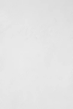 A white wall with a subtle plaster texture