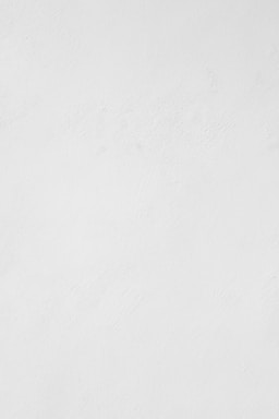 a man riding a snowboard down a snow covered slope