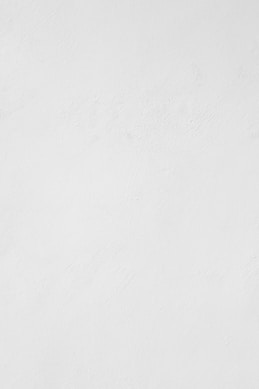 a man riding a snowboard down a snow covered slope