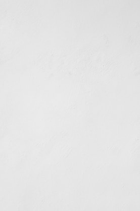 a man riding a snowboard down a snow covered slope