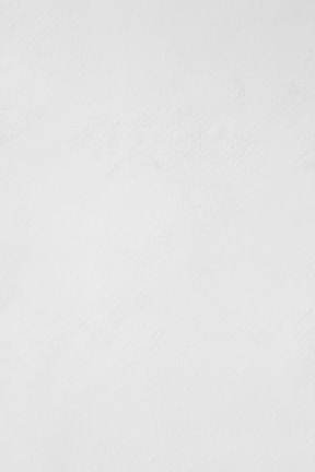 a man riding a snowboard down a snow covered slope