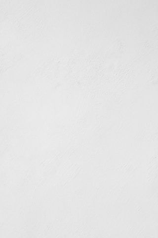 a man riding a snowboard down a snow covered slope