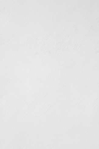 a man riding a snowboard down a snow covered slope