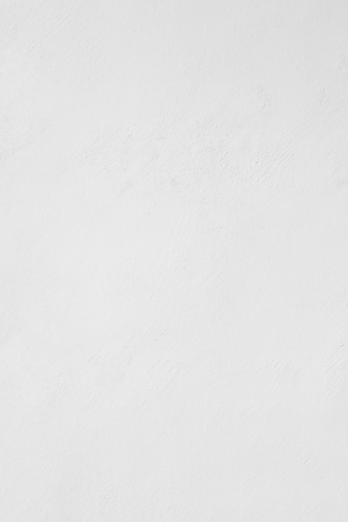 a man riding a snowboard down a snow covered slope