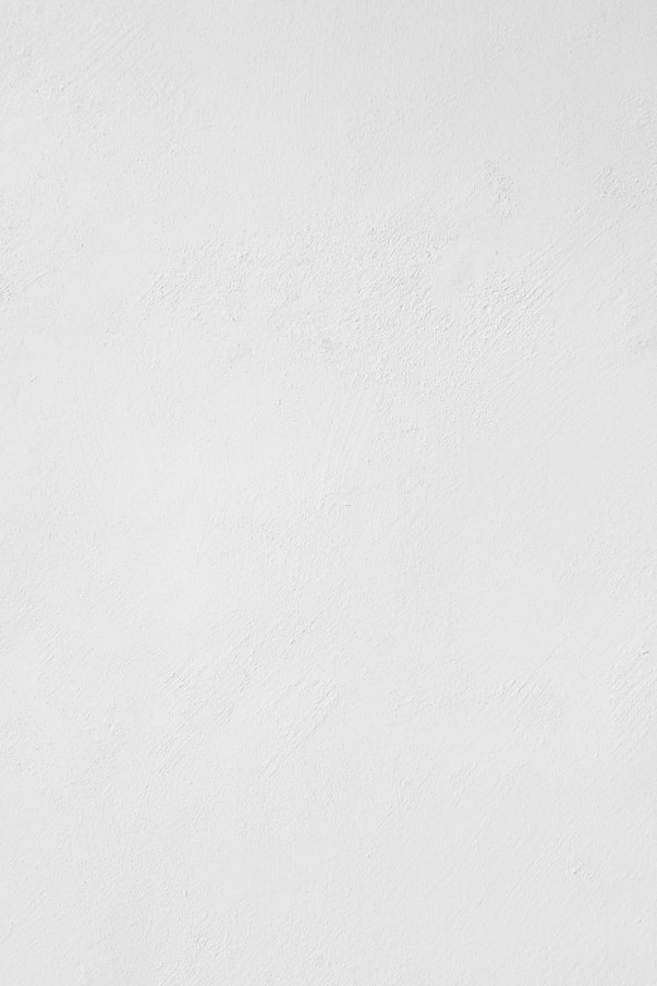a man riding a snowboard down a snow covered slope