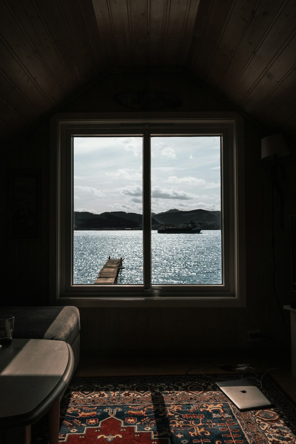 boat in body of water through glass window