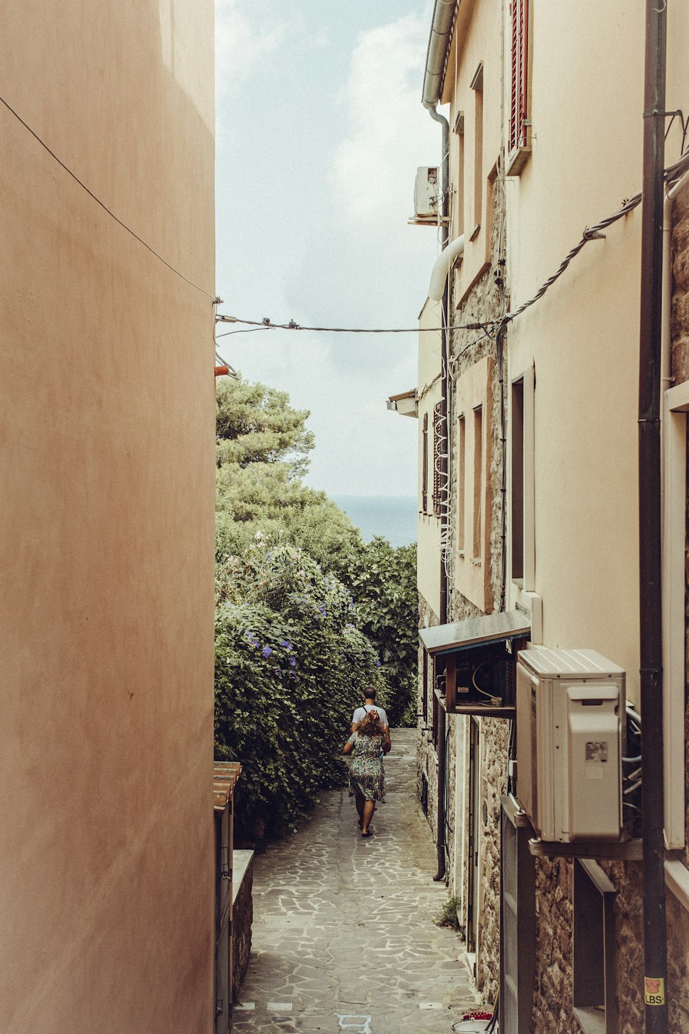 man and woman walks at the side of the apartment