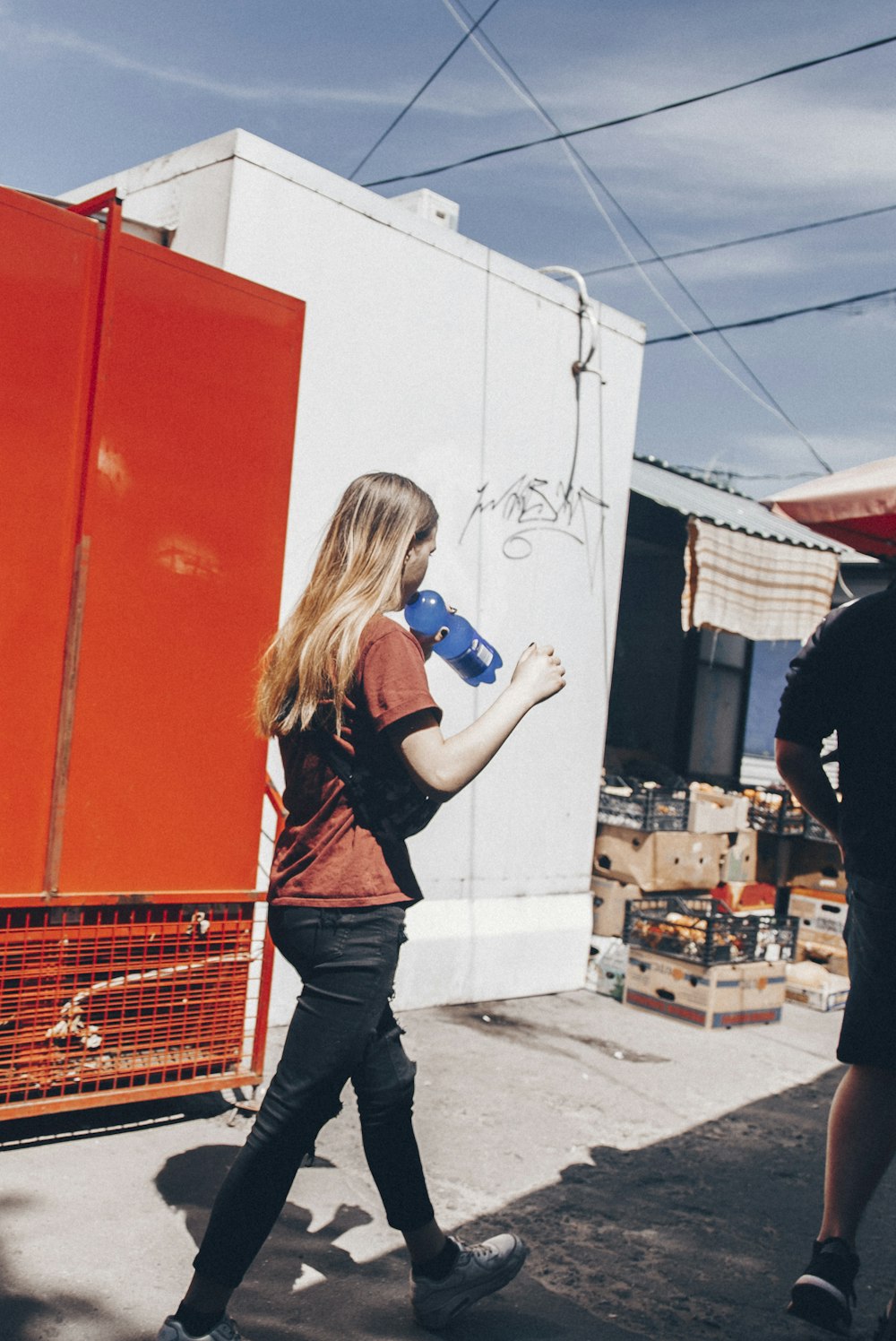 woman holding blue plastic bottle