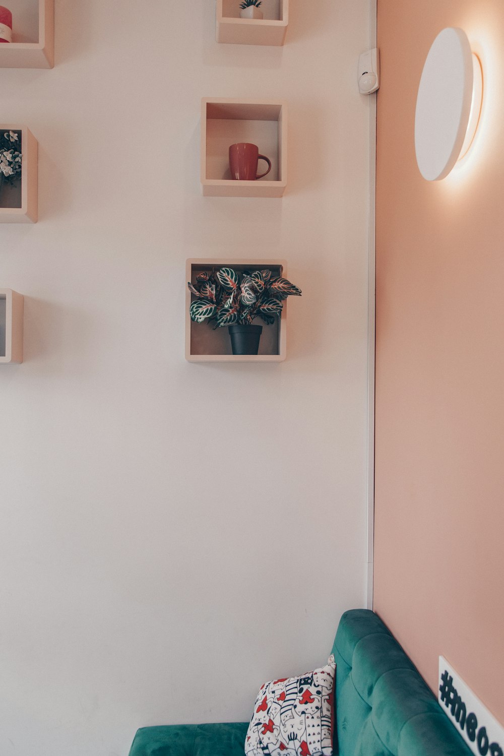 a living room with a couch and shelves on the wall