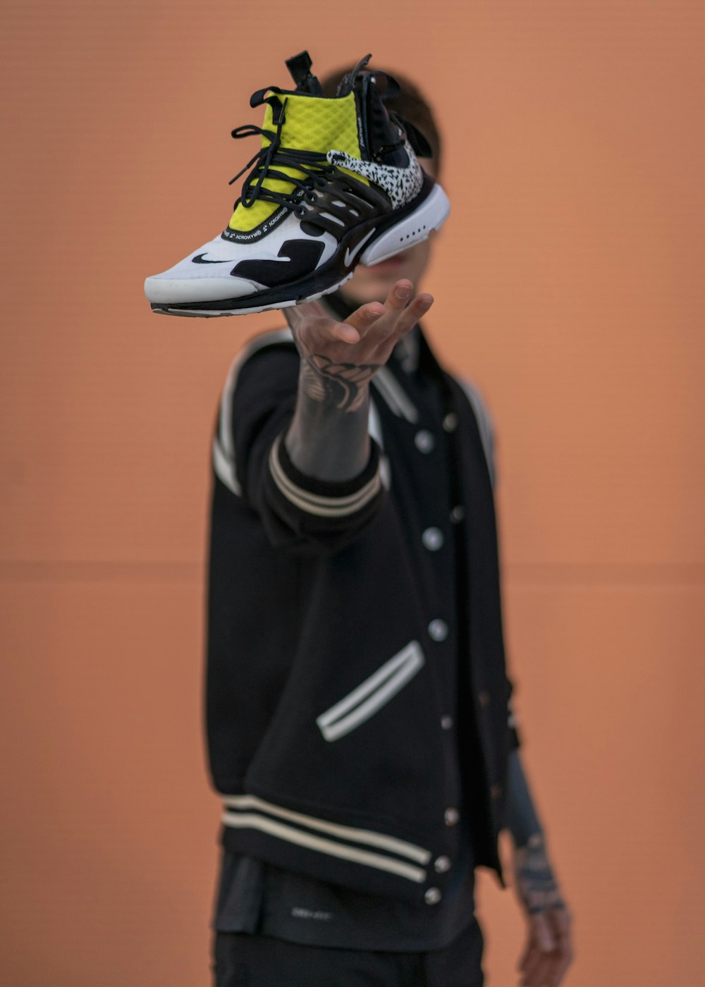 black, white, and yellow Nike high-top shoe