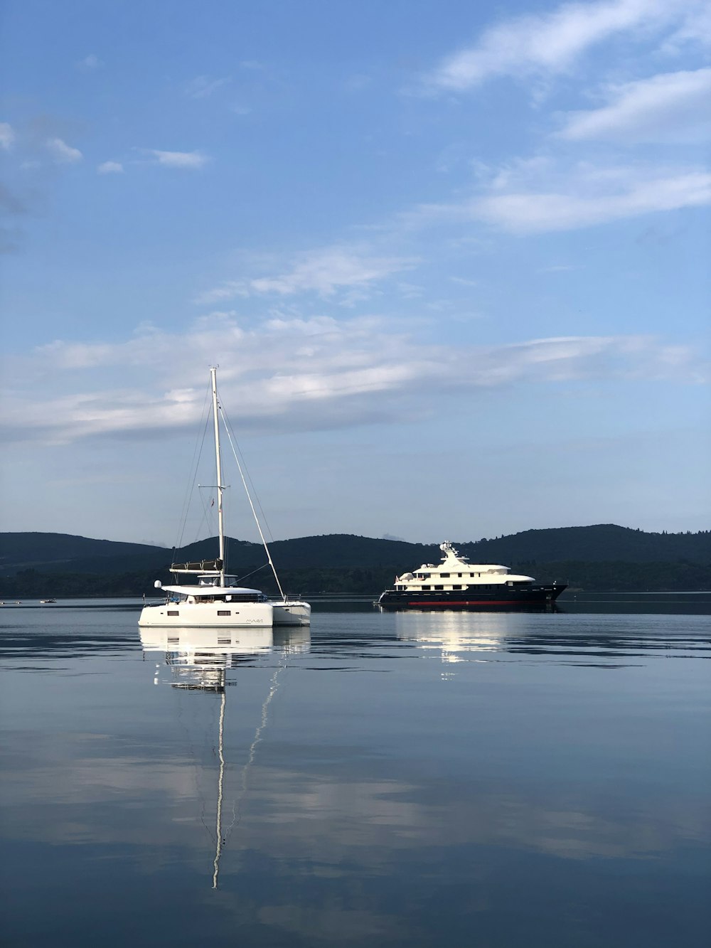 white boats in sea under blue sky