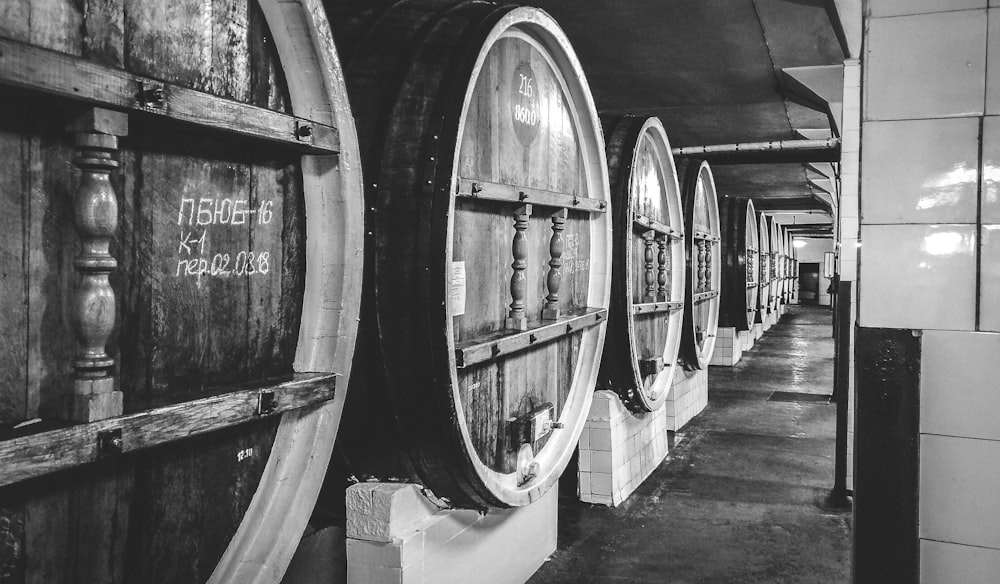 grayscale photo of wine barrels